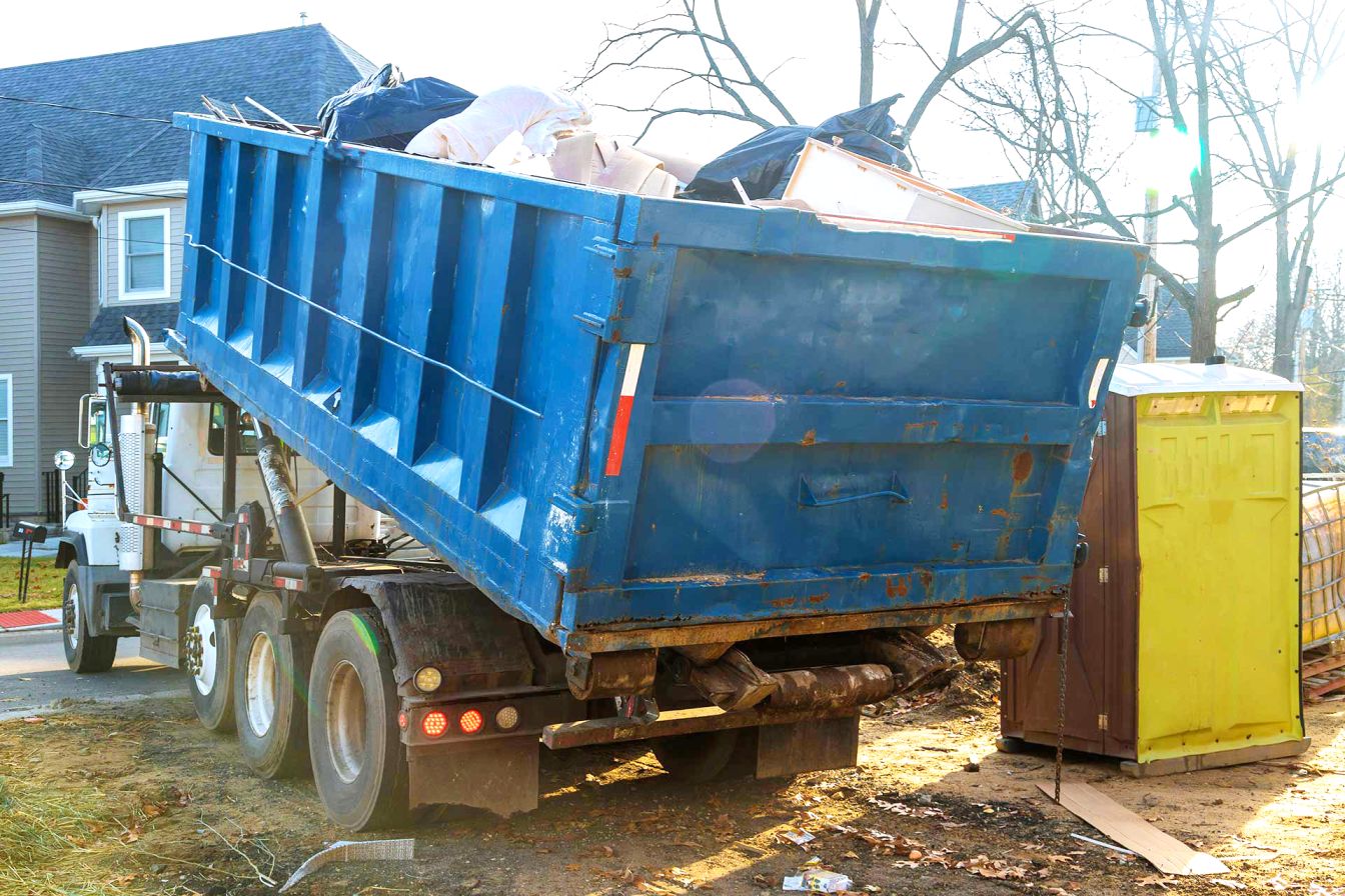 Trash dumpsters loading the garbage container construction material