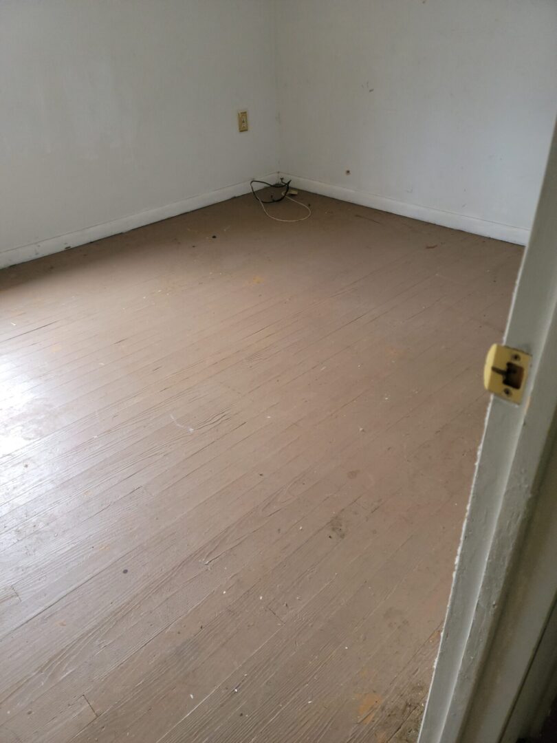 An Empty Room With Wood Paneled Flooring