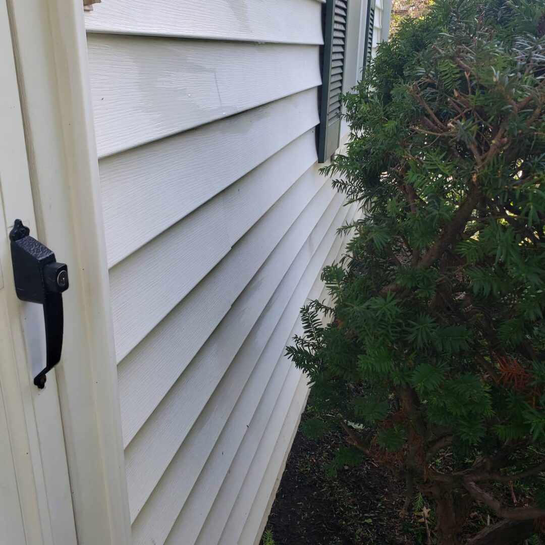 A black handle on a white door of a house