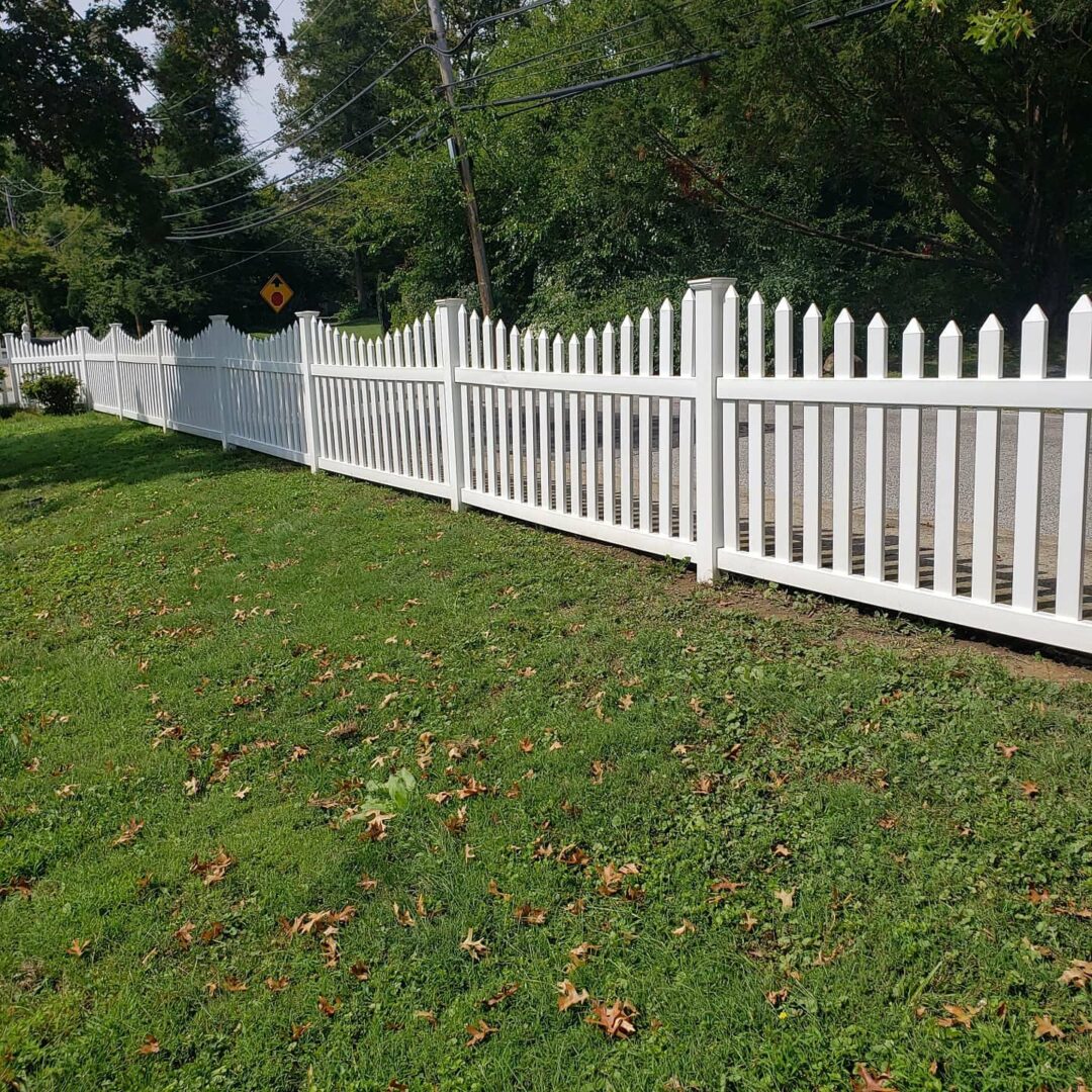 White fence with a green garden