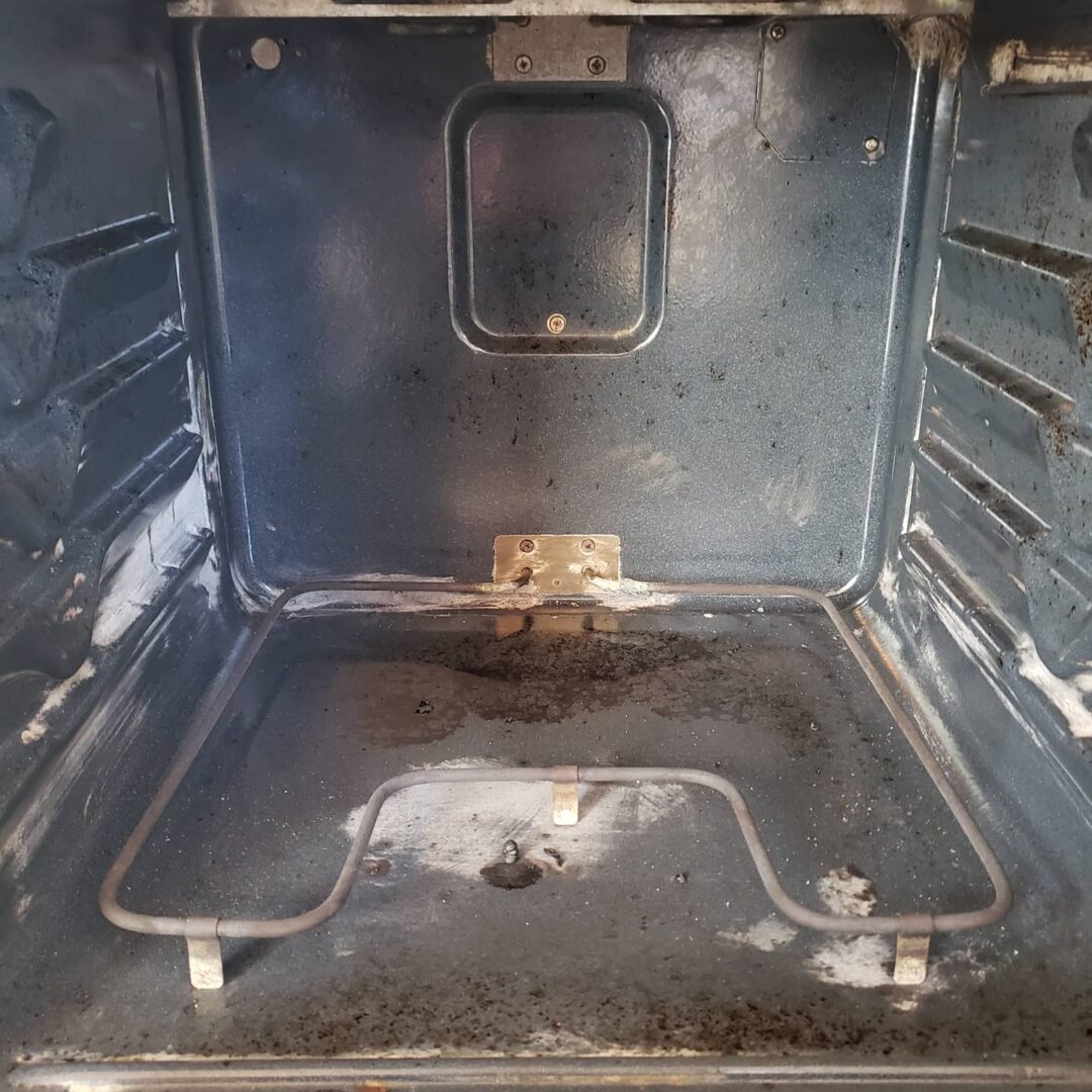 A metal interior of a machine with dirt stains