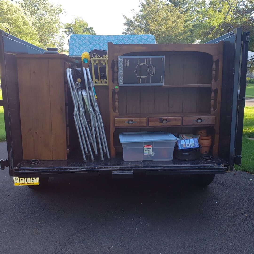 A truck loaded with house items and cabinets
