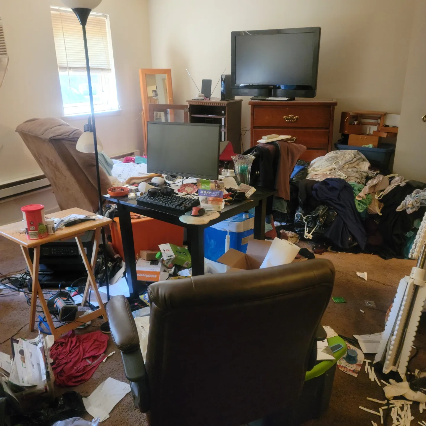 A dirty untidy house with clothes and trash
