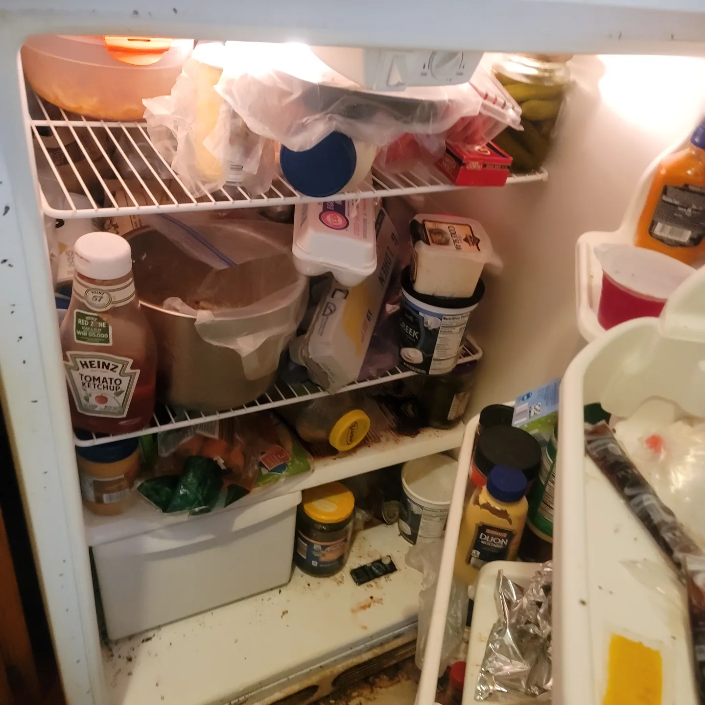 An untidy fridge with used food items